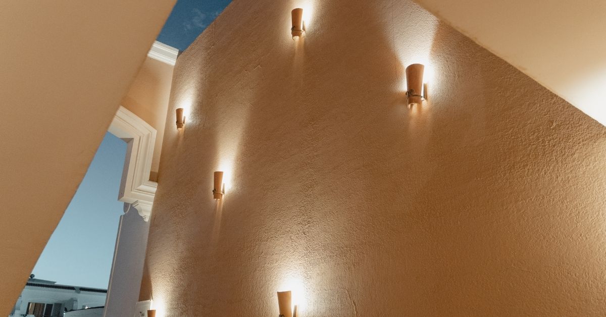 Warmly lit staircase wall with modern wall sconces, perfect example of interior wall decor ideas for elegant spaces.