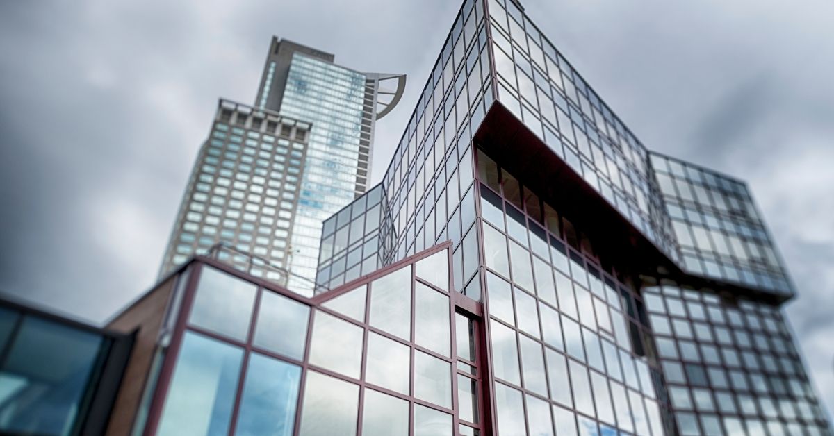 ChatGPT said:

The image shows a modern high-rise building with a striking, angular design and a glass façade. The structure features irregularly stacked sections, giving it a dynamic and futuristic appearance.
