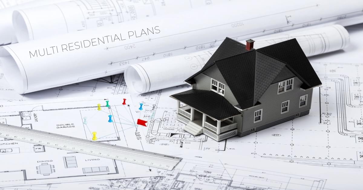 Architectural house model placed on construction blueprints with measurement tools representing with multi residential plans design planning
